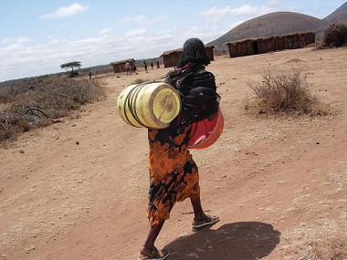 woman-carrying-water-barrell-small